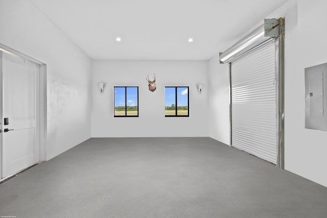 unfurnished room with electric panel and recessed lighting