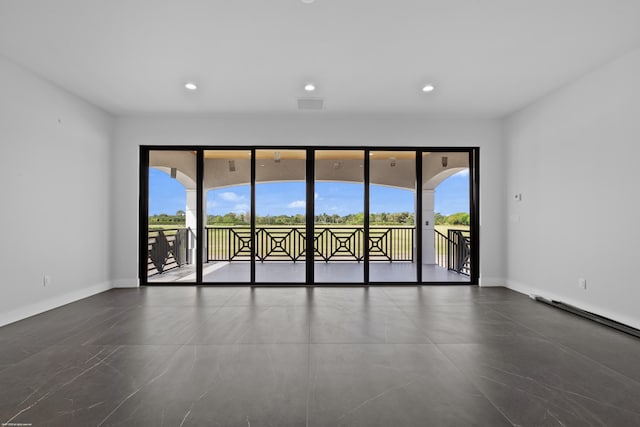 unfurnished room with plenty of natural light, baseboards, and recessed lighting