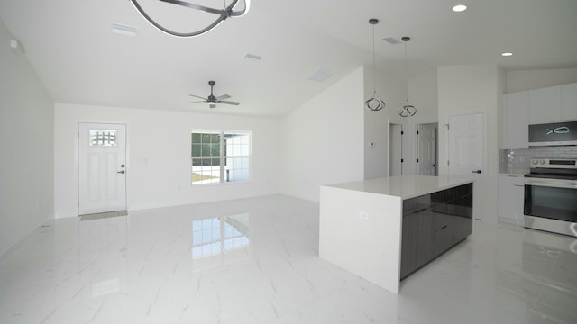 kitchen with marble finish floor, modern cabinets, a kitchen island, and stainless steel range with electric cooktop