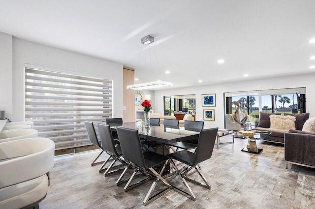 dining area featuring wood finished floors and recessed lighting