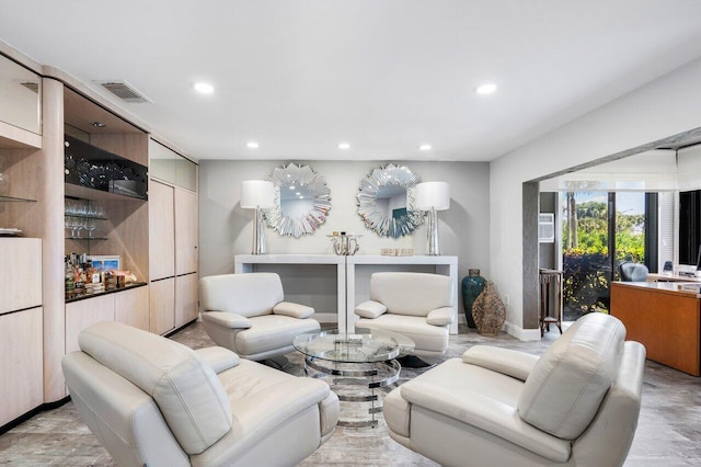 living area with visible vents and recessed lighting