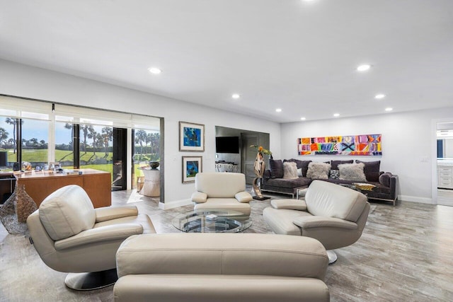 living room with light wood-style flooring, baseboards, and recessed lighting