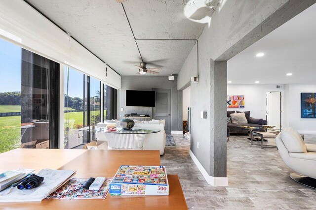 interior space with ceiling fan