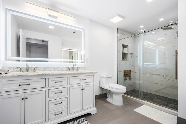 full bathroom featuring toilet, a marble finish shower, and a sink