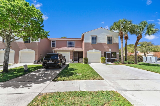 view of front of home featuring stucco siding, an attached garage, concrete driveway, and a front yard