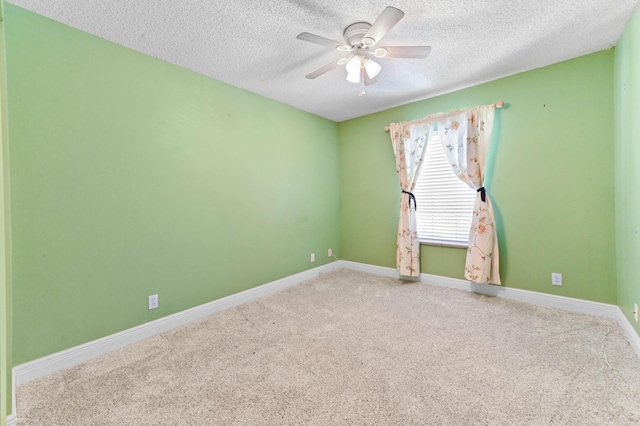 carpeted empty room featuring baseboards, a textured ceiling, and ceiling fan