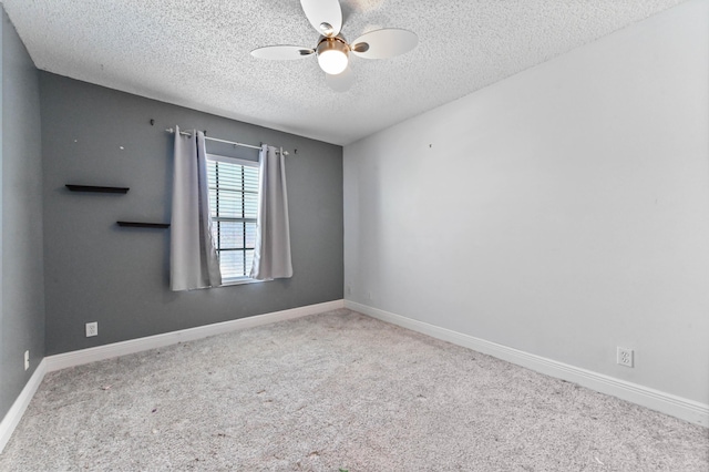 unfurnished room with carpet flooring, a ceiling fan, and baseboards