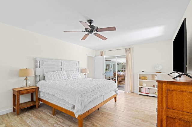 bedroom with a ceiling fan, light wood-type flooring, and baseboards