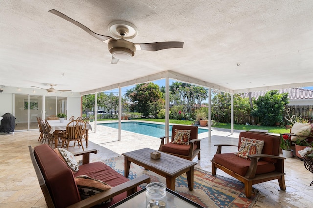 outdoor pool featuring a ceiling fan, a patio area, a fenced backyard, and an outdoor hangout area