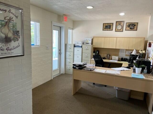 carpeted office space featuring recessed lighting and a textured ceiling