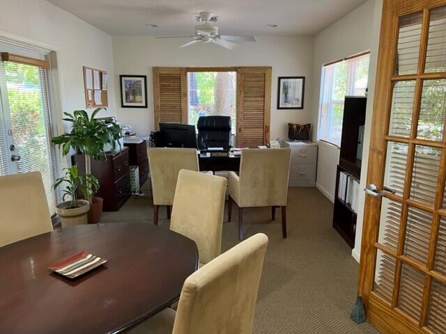 dining room featuring carpet floors and a ceiling fan