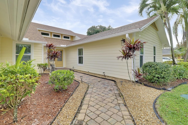 exterior space featuring a shingled roof