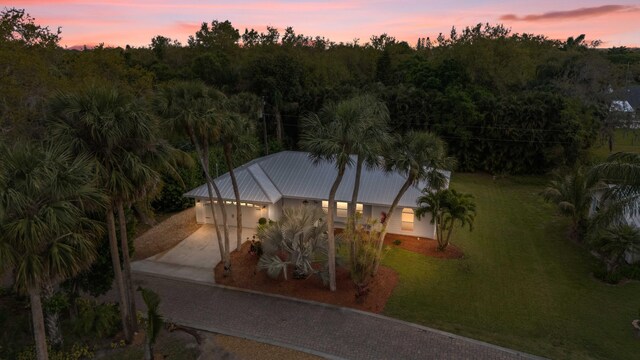 aerial view at dusk with a view of trees