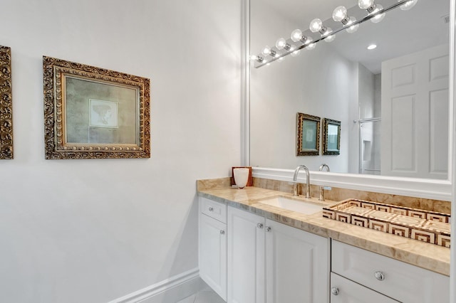 bathroom featuring vanity and baseboards