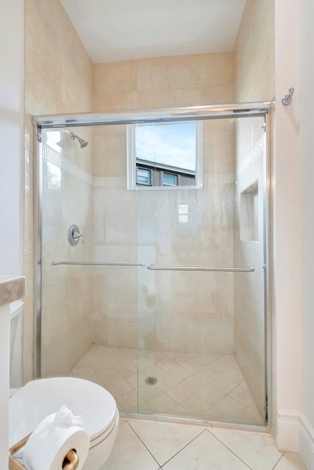 bathroom featuring a shower stall and toilet