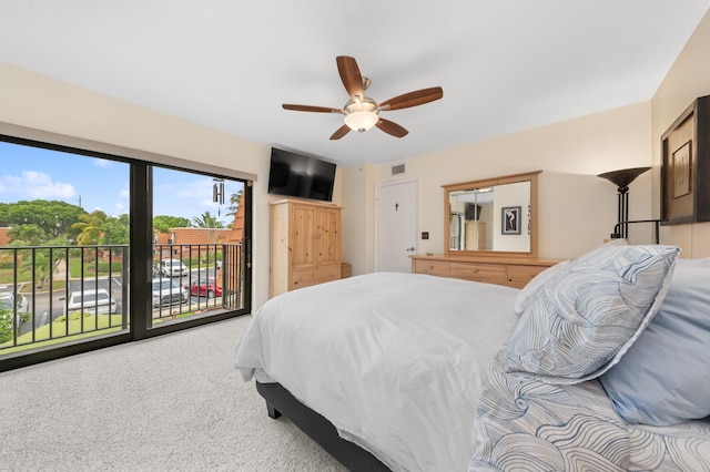 carpeted bedroom with access to outside, visible vents, and ceiling fan