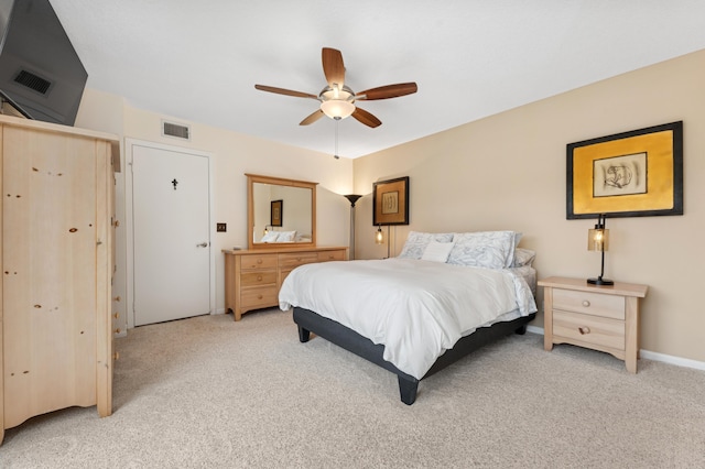 bedroom with ceiling fan, visible vents, and light colored carpet