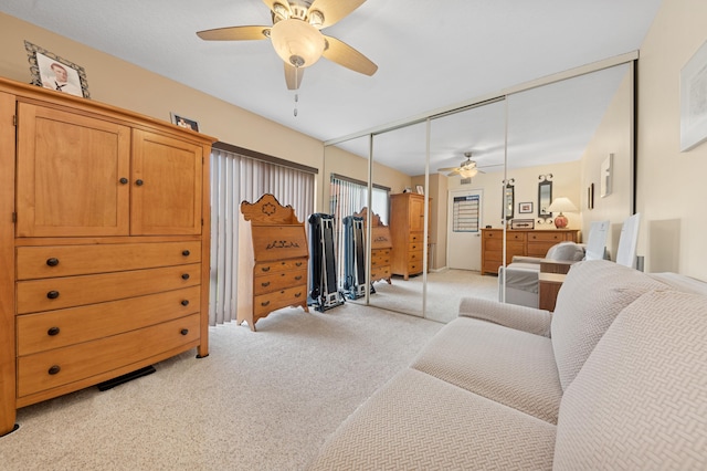 interior space featuring ceiling fan and light colored carpet