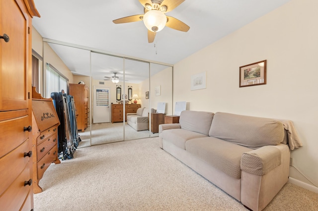 living room featuring light carpet and ceiling fan