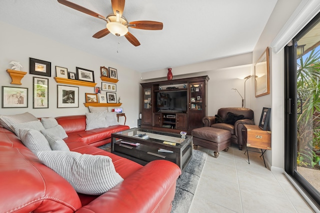 living room featuring a wealth of natural light, a ceiling fan, and tile patterned floors