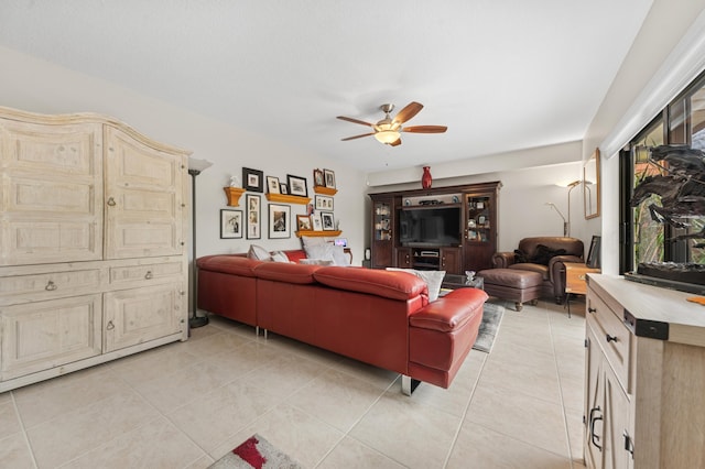 living room with a ceiling fan and light tile patterned floors