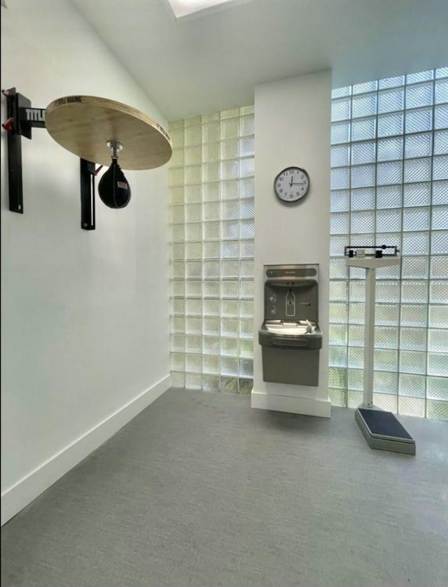 bathroom featuring vaulted ceiling and baseboards
