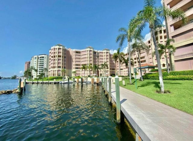 dock area featuring a water view and a yard