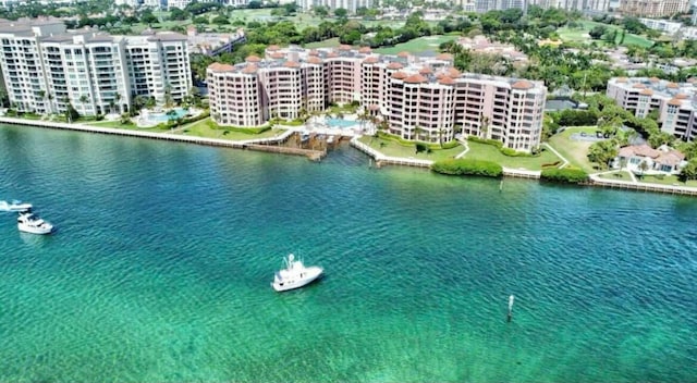 birds eye view of property with a view of city and a water view