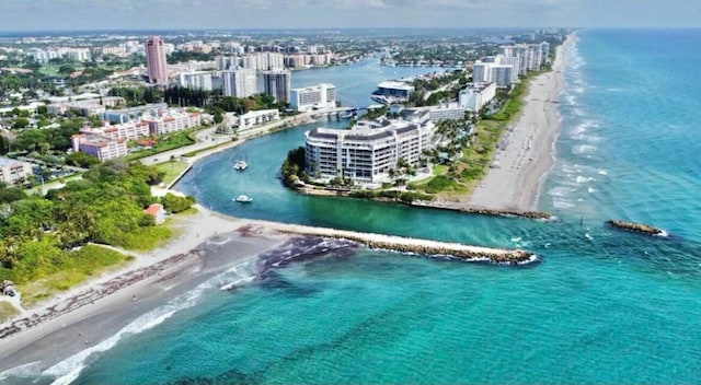 aerial view featuring a water view, a beach view, and a city view