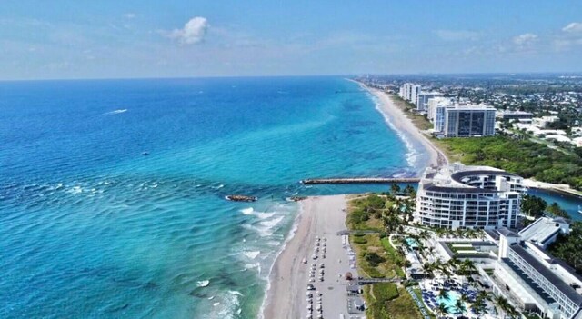 aerial view with a view of the beach, a water view, and a city view