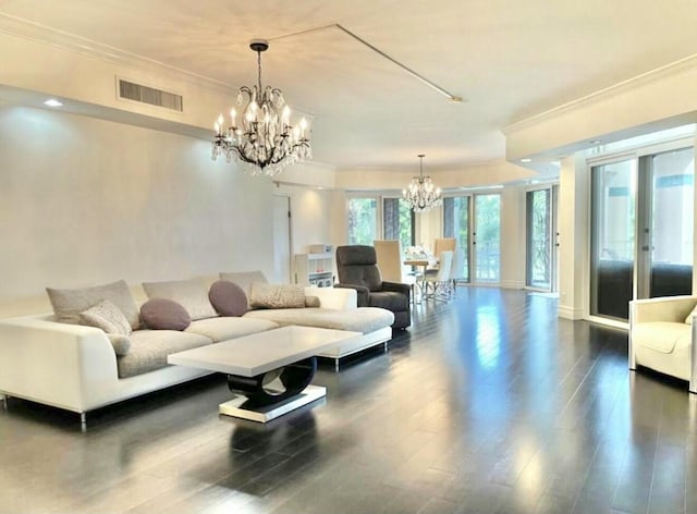 living area featuring visible vents, a chandelier, dark wood-style flooring, and ornamental molding