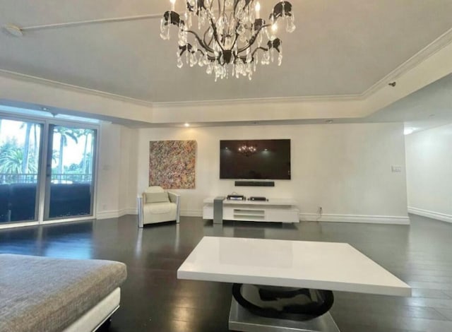 living room with baseboards, ornamental molding, a raised ceiling, and wood finished floors
