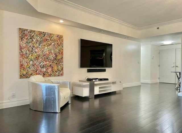 unfurnished living room featuring baseboards, wood finished floors, and crown molding
