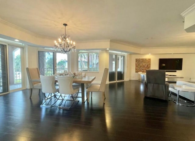 dining room with baseboards, a chandelier, wood finished floors, and ornamental molding
