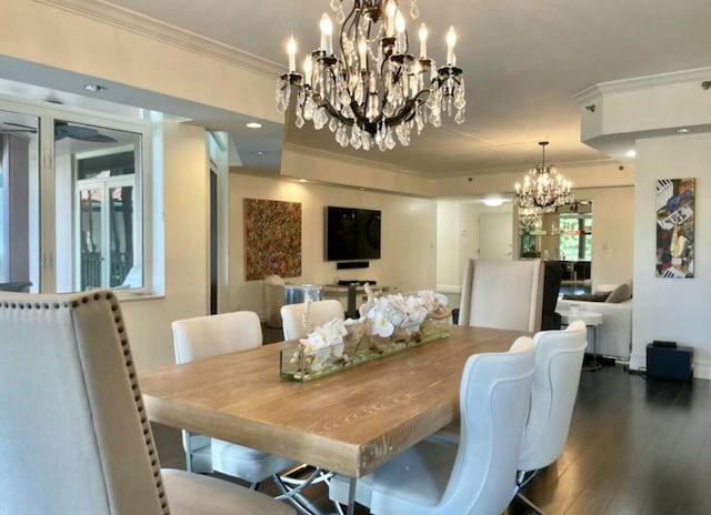 dining room with ornamental molding, a chandelier, and wood finished floors