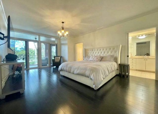 bedroom with ensuite bath, ornamental molding, dark wood-type flooring, an inviting chandelier, and access to outside