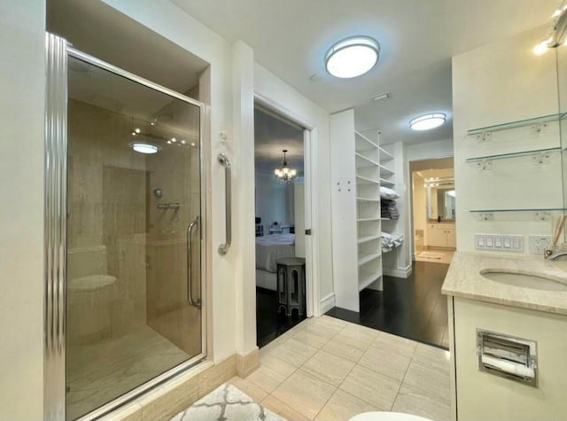 full bathroom with a shower stall, baseboards, tile patterned flooring, and vanity