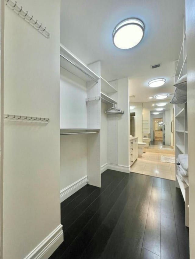 walk in closet with wood-type flooring and visible vents