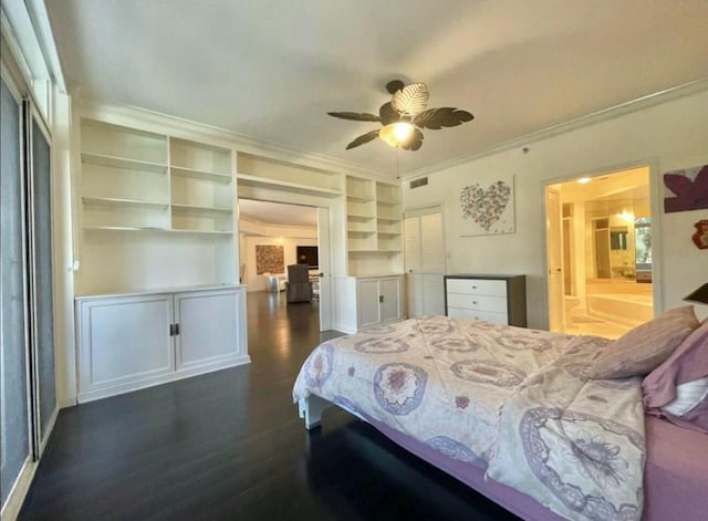bedroom with ornamental molding, visible vents, dark wood finished floors, and ensuite bathroom