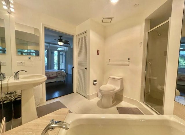 bathroom with a stall shower, baseboards, toilet, ensuite bath, and tile patterned flooring