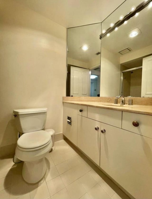 bathroom with toilet, a shower stall, visible vents, and vanity