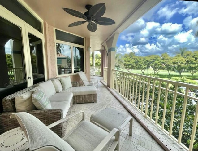 balcony with an outdoor hangout area and ceiling fan