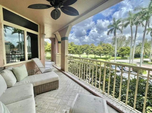 balcony with outdoor lounge area and a ceiling fan