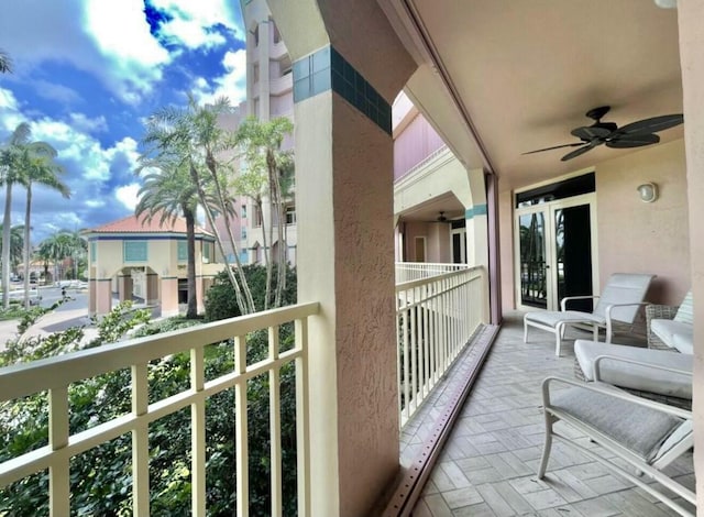 balcony with a ceiling fan and french doors
