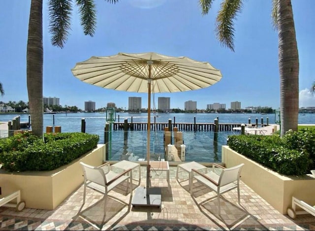 exterior space with a water view and a city view