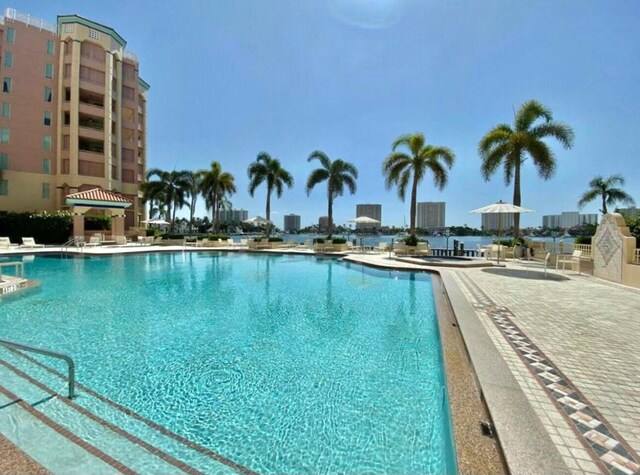 pool with a gazebo, a patio area, and a city view