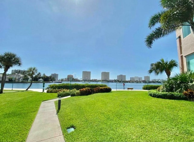 view of property's community featuring a yard, a water view, and a city view
