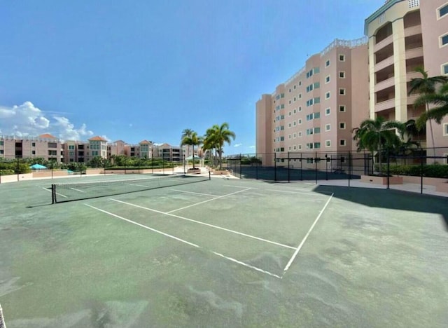 view of tennis court featuring fence