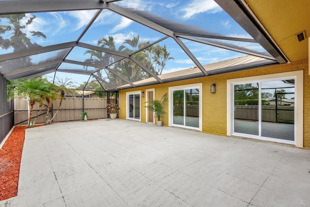 unfurnished sunroom featuring lofted ceiling