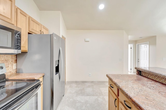 kitchen featuring light brown cabinets, stainless steel appliances, backsplash, and recessed lighting